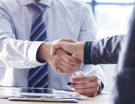 Two people shaking hands, illustrating a candidate who has provided references on their CV to an employer