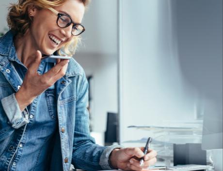 Woman holding a phone to symbolize including contact information on your resume