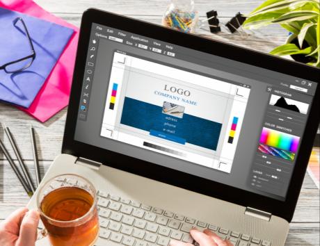 A laptop with an image editing software open to illustrate crafting a creative CV