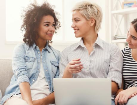 Two women speaking with a laptop to illustrate a strong resume summary
