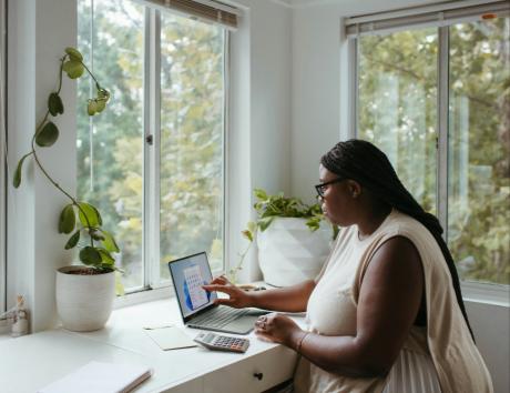 A woman typing on a laptop to indicate adding projects to your CV