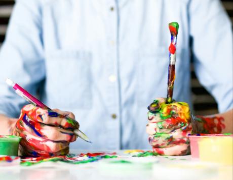 A person painting to illustrate making a creative resume