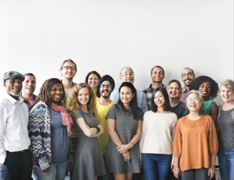 Group of diverse people standing together against a white background to illustrate nationality on resume